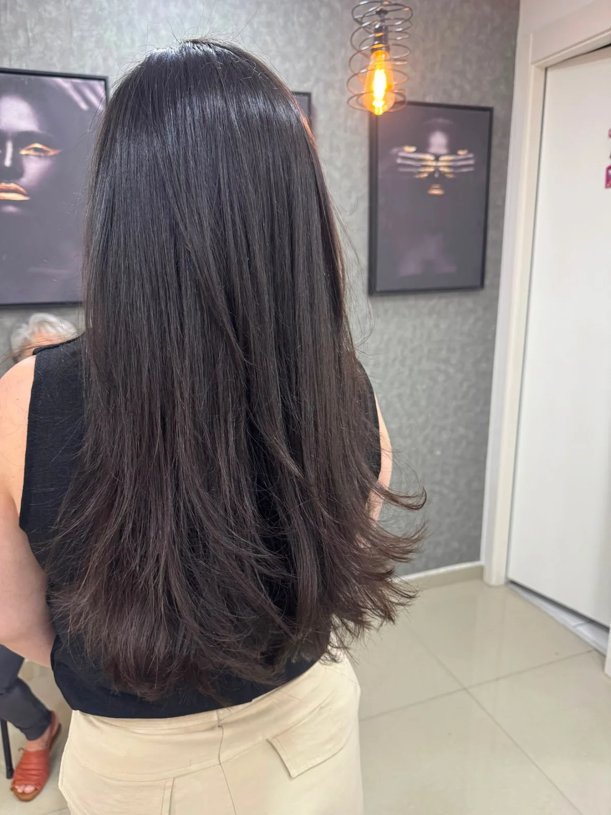 Cabelo escuro longo e brilhoso após tratamento capilar